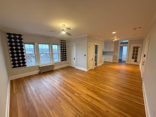 21 Bradlee Road, Unit 52 Medford, MA 02155 - Photo 2 of 22 a view of an empty room with a window and wooden floor