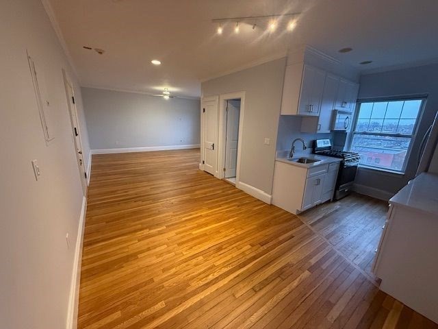 21 Bradlee Road, Unit 52 Medford, MA 02155 - Photo 3 of 22 a view of a kitchen with wooden floor