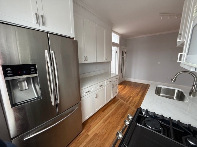 21 Bradlee Road, Unit 52 Medford, MA 02155 - Photo 6 of 22 a kitchen with granite countertop a refrigerator and a sink