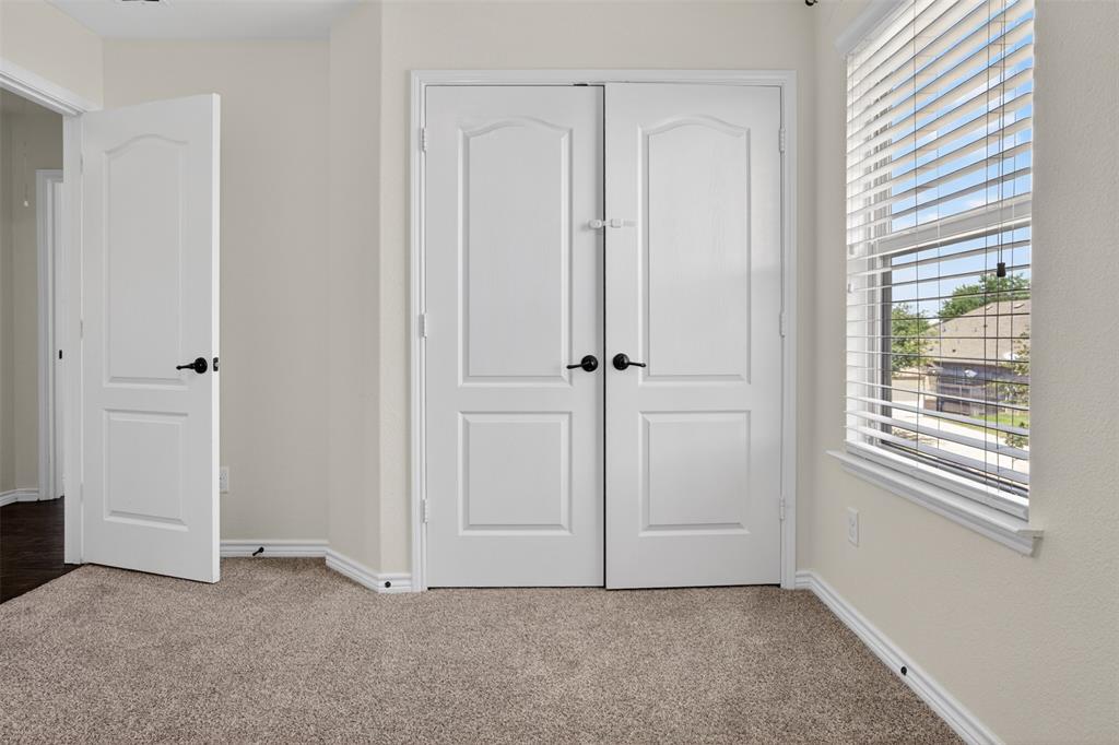 8728 Maple Ridge Trail Fort Worth, TX 76244 - Photo 31 of 40 Neutral-toned textured carpeting paired with white baseboards and walls