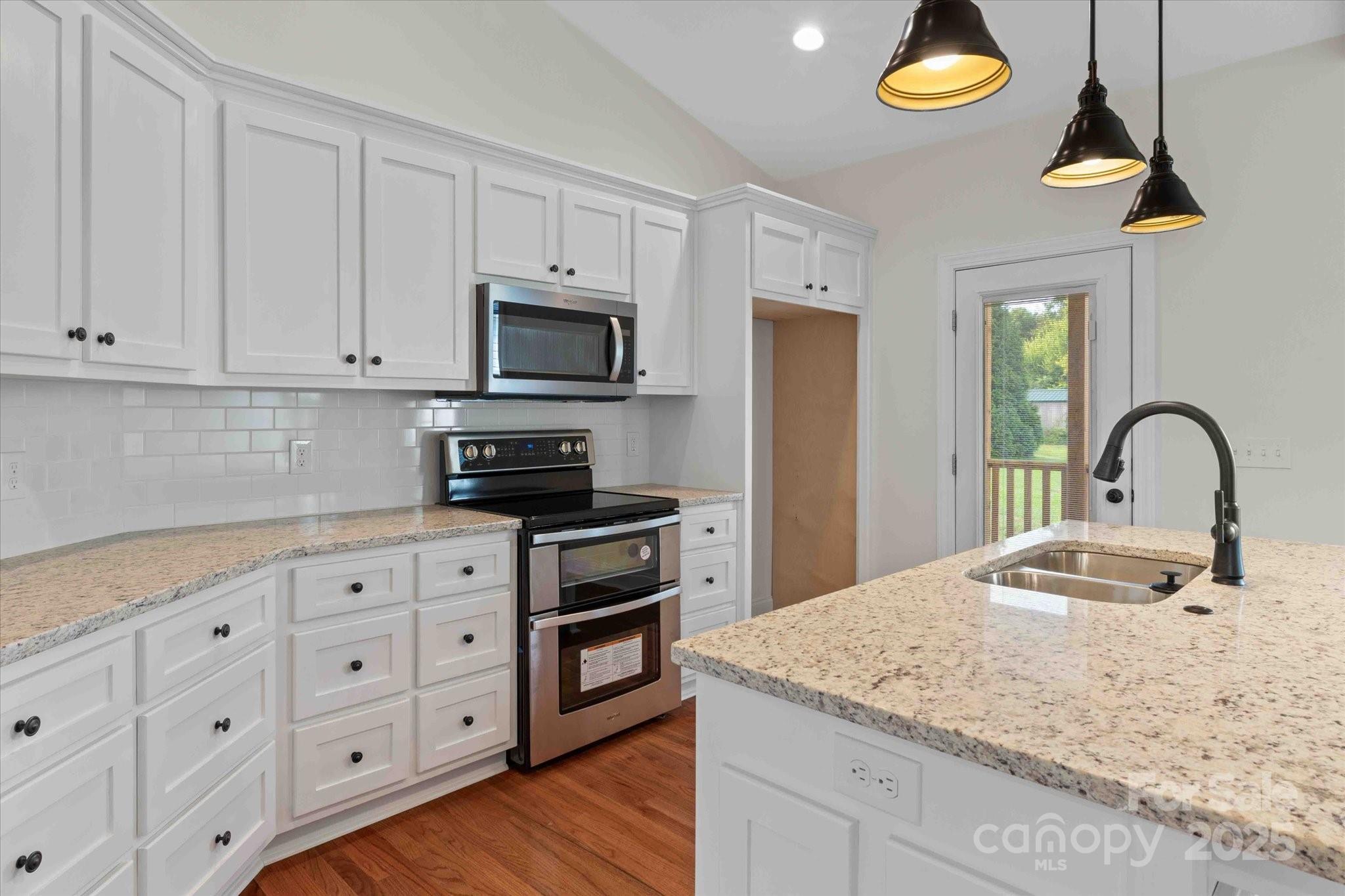 113 Cheval Trail Cleveland, NC 27013 - Photo 13 of 41 a kitchen with granite countertop a stove sink and cabinets