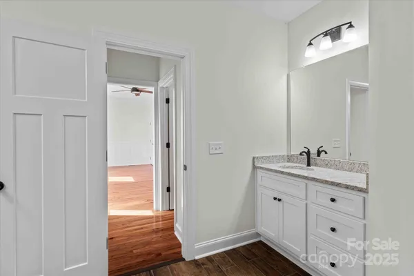 a bathroom with a sink a mirror and wooden
