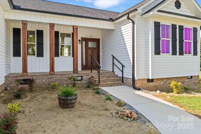 a view of a house with potted plants