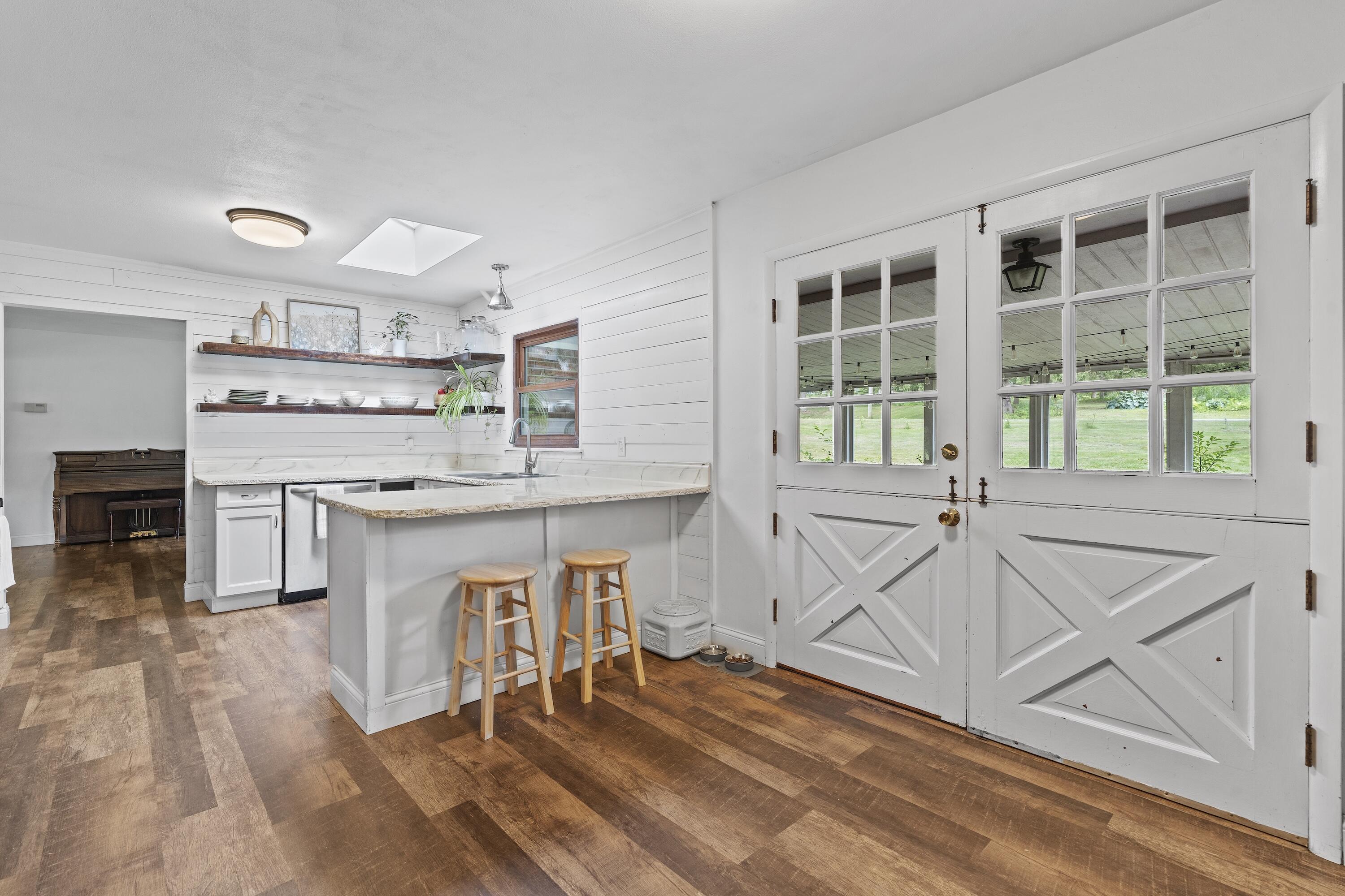 N8093 Lakeview Road Oconomowoc, WI 53066 - Photo 11 of 44 Space for a table in your kitchen, double doors to your attached screened in porch.