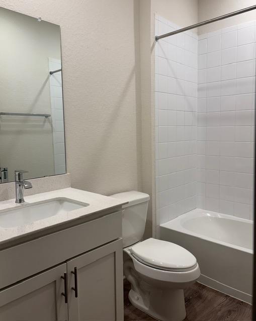 10925 Defender Trail Austin, TX 78754 - Photo 5 of 7 A well-appointed bathroom offers modern fixtures and a pristine shower/tub combination.