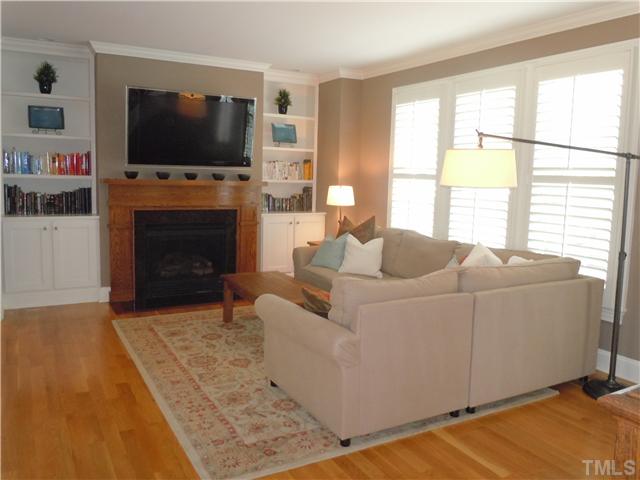1305 Lions Way Raleigh, NC 27604 - Photo 6 of 25 a living room with furniture a flat screen tv and a fireplace