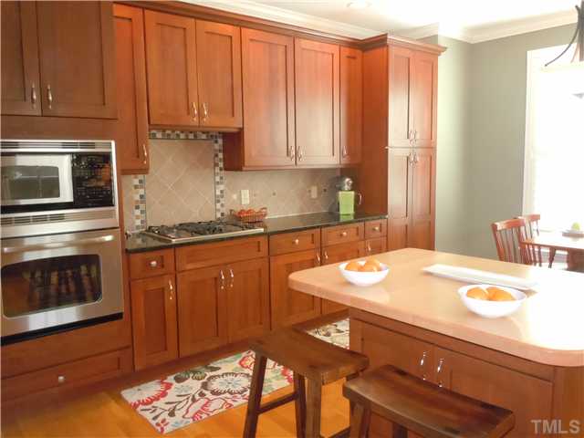 1305 Lions Way Raleigh, NC 27604 - Photo 8 of 25 a kitchen with stainless steel appliances a stove a sink and cabinets
