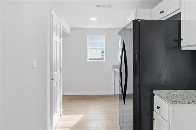 a view of cabinets with refrigerator