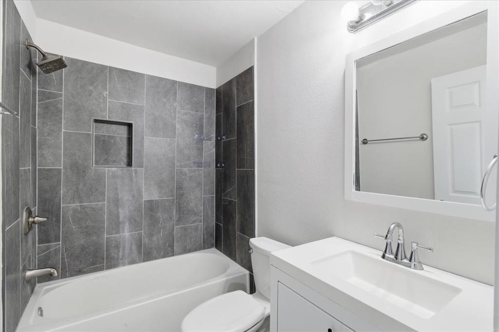 404 South Murray Street McKinney, TX 75069 - Photo 21 of 24 a bathroom with a bathtub shower sink vanity and toilet