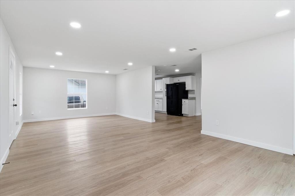 404 South Murray Street McKinney, TX 75069 - Photo 6 of 24 a view of an empty room with a window and a kitchen