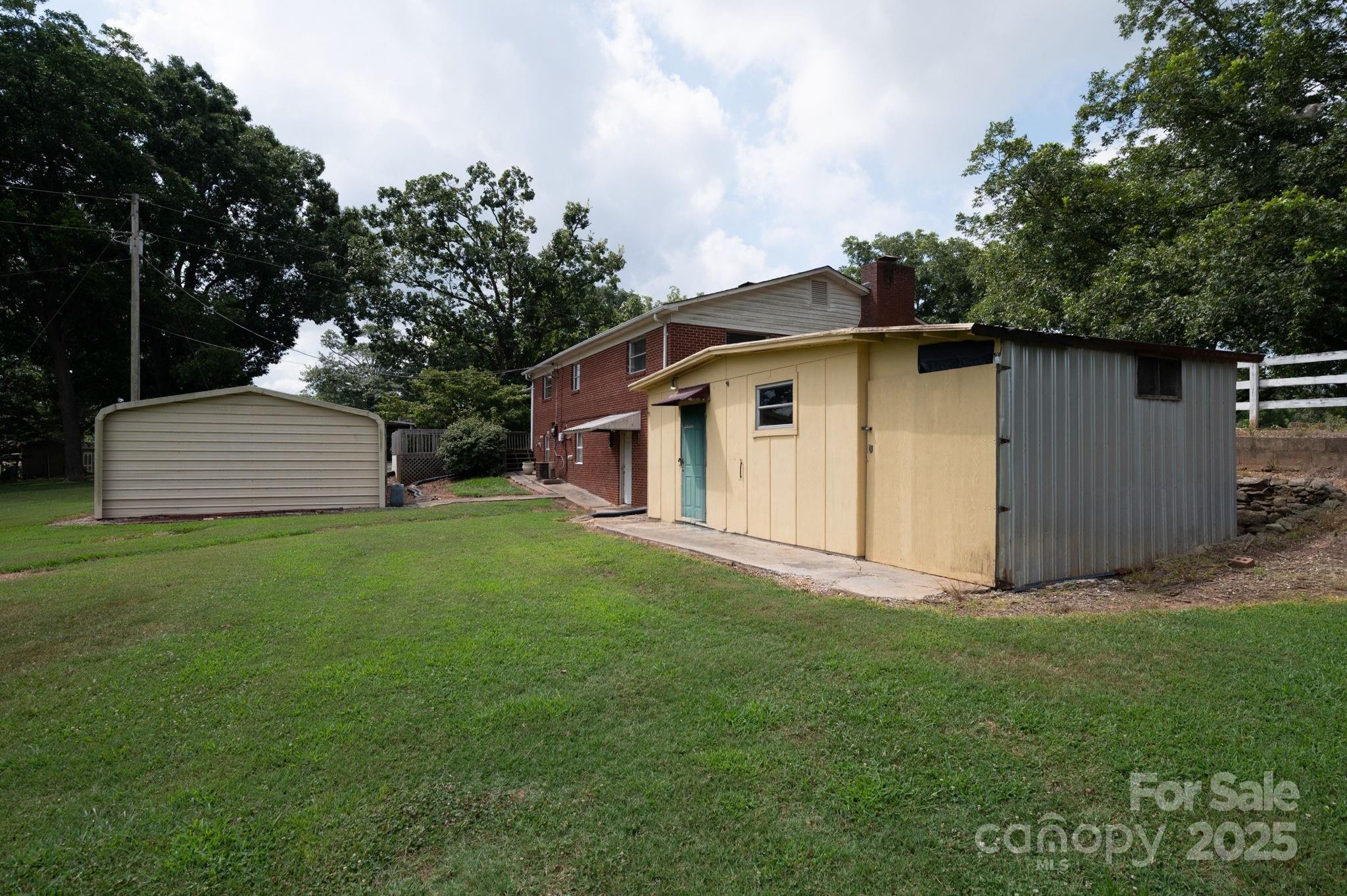 1585 Salem Church Road Lincolnton, NC 28092 - Photo 30 of 31 a view of a backyard with barn and large trees