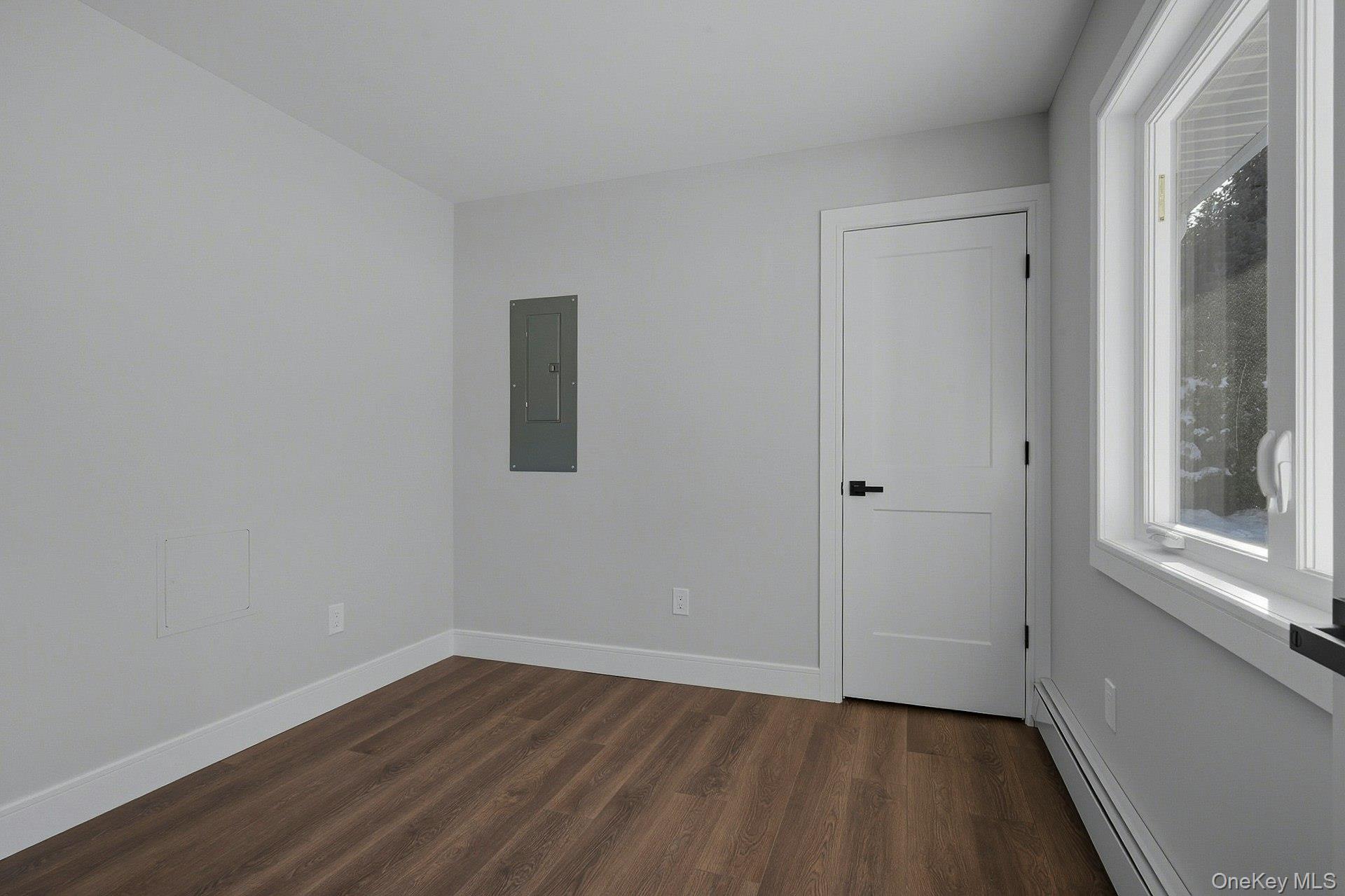 73 Wolcott Road Levittown, NY 11756 - Photo 13 of 31 a view of an empty room with wooden floor and a window