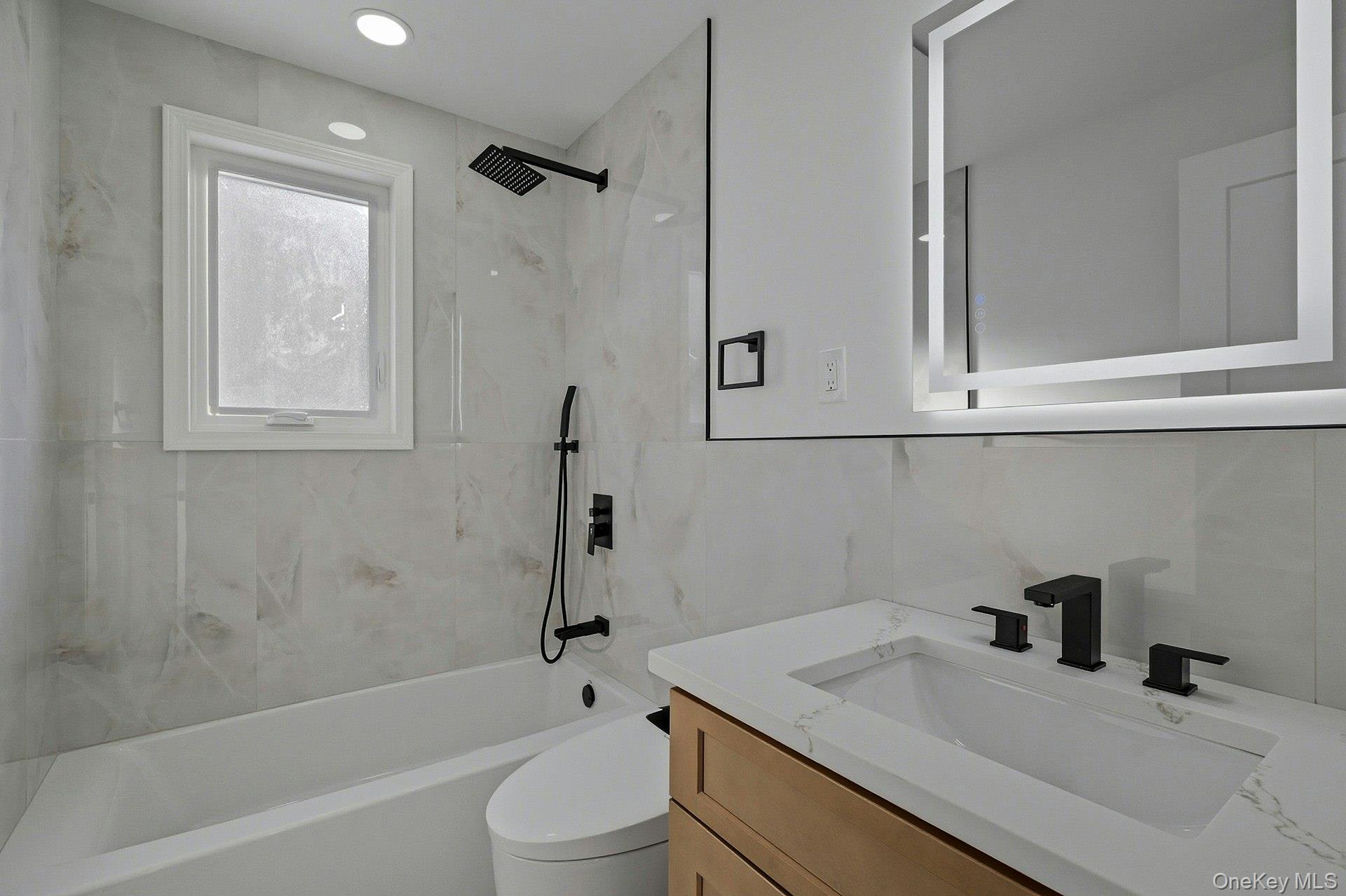 73 Wolcott Road Levittown, NY 11756 - Photo 15 of 31 a bathroom with a sink toilet vanity and shower
