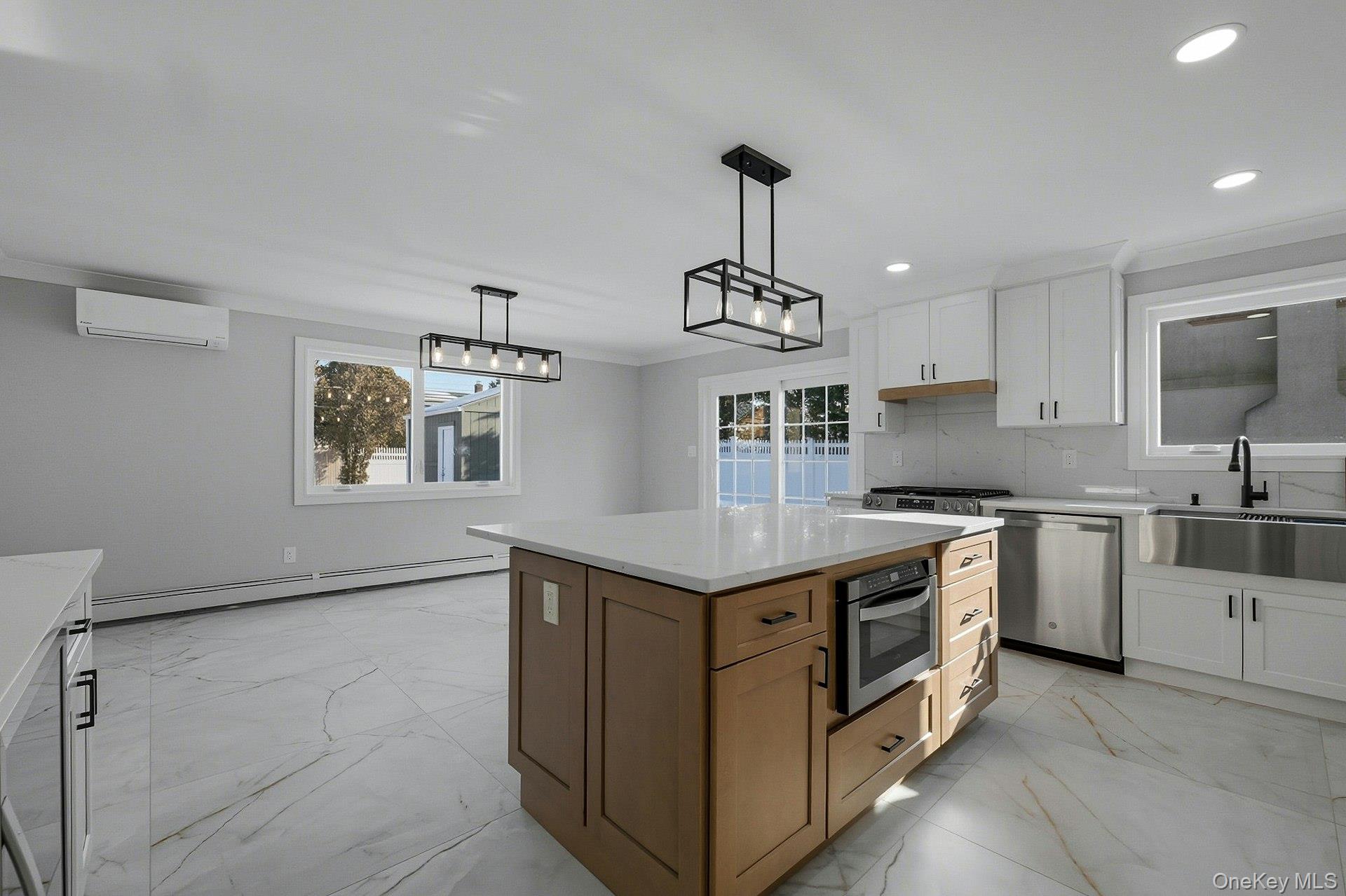 73 Wolcott Road Levittown, NY 11756 - Photo 16 of 31 a kitchen with stainless steel appliances granite countertop a sink and a stove