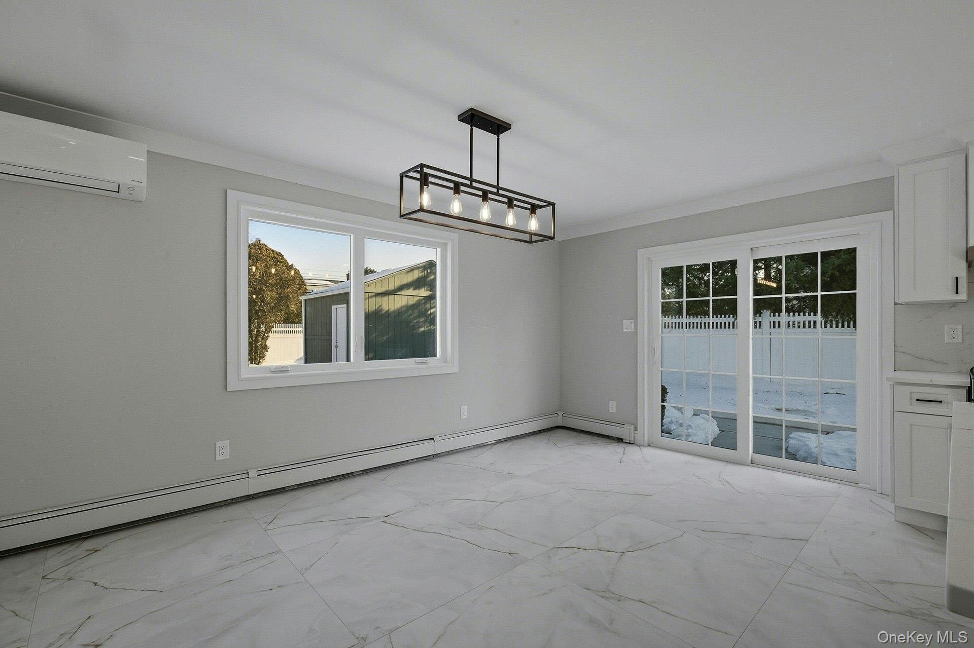 73 Wolcott Road Levittown, NY 11756 - Photo 17 of 31 an empty room with windows and ceiling fan