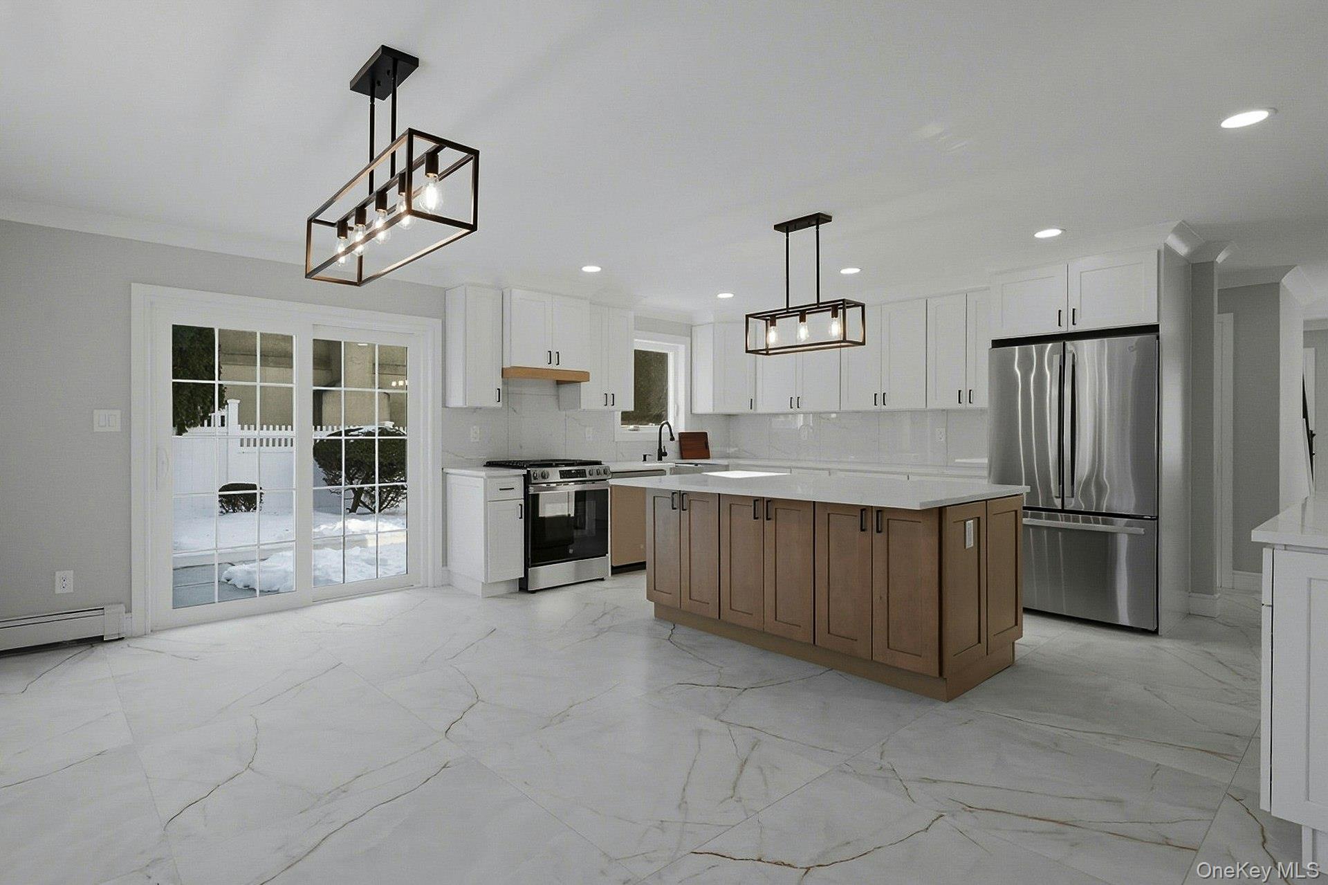 73 Wolcott Road Levittown, NY 11756 - Photo 18 of 31 a kitchen with stainless steel appliances granite countertop a refrigerator and a sink