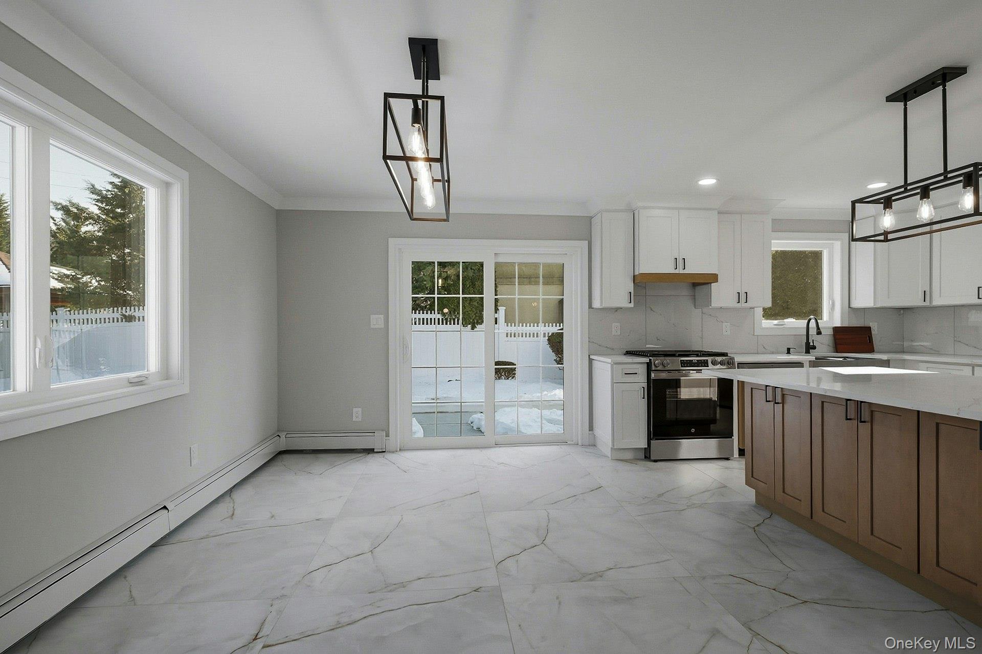 73 Wolcott Road Levittown, NY 11756 - Photo 19 of 31 a large kitchen with stainless steel appliances granite countertop a stove a sink a microwave and a refrigerator