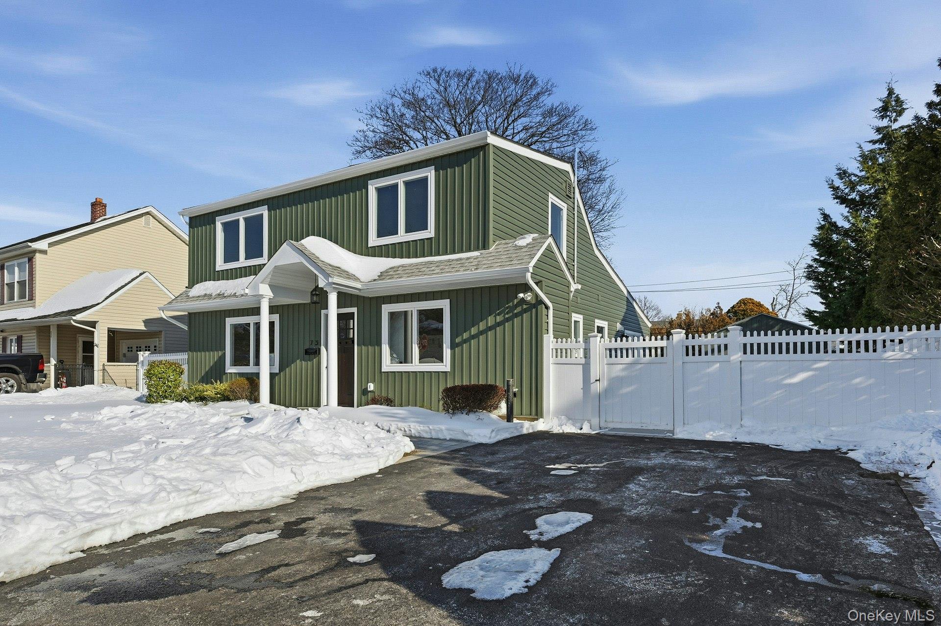 73 Wolcott Road Levittown, NY 11756 - Photo 2 of 31 a front view of a house with a yard