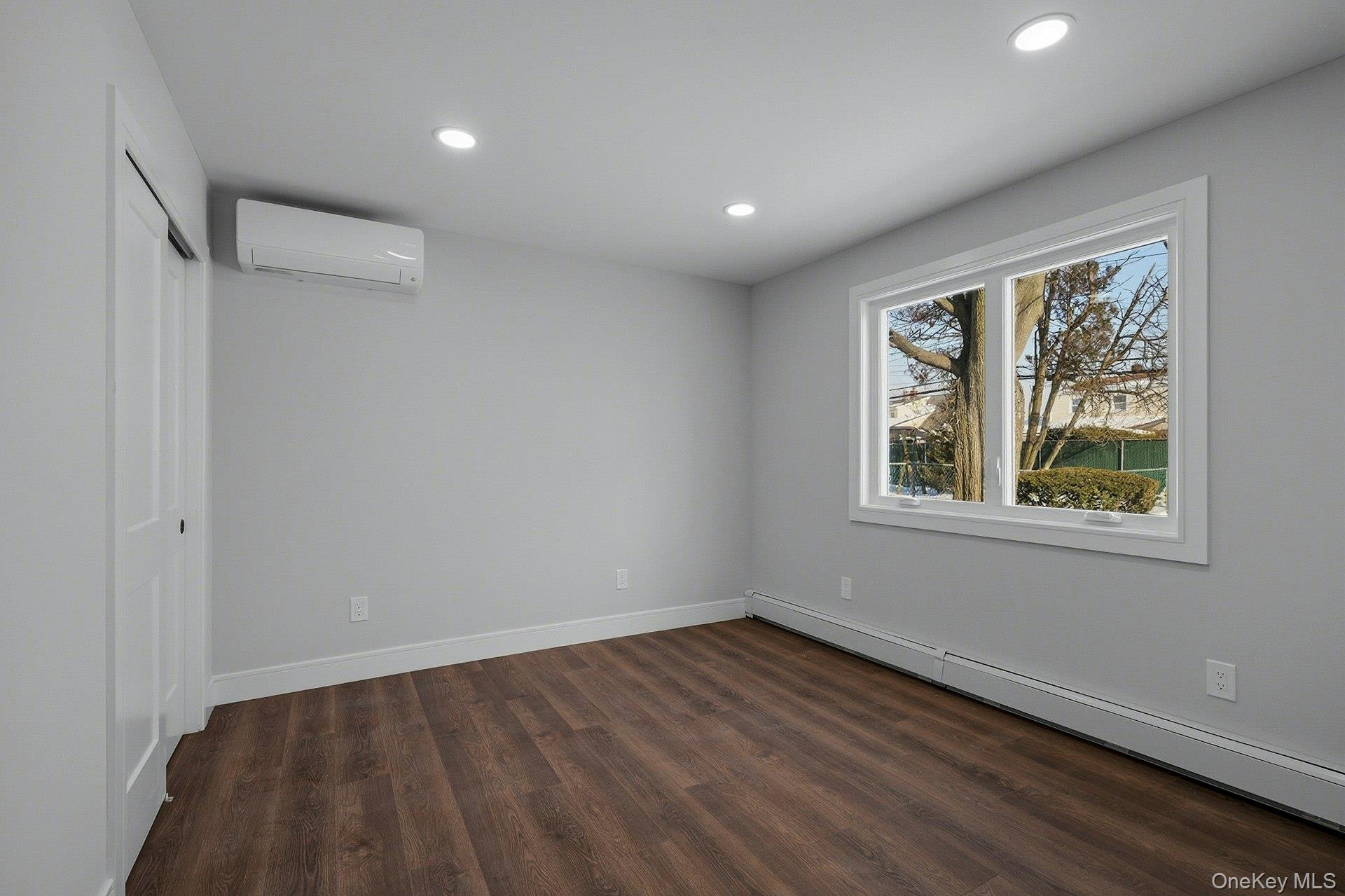 73 Wolcott Road Levittown, NY 11756 - Photo 25 of 31 a view of an empty room with wooden floor and a window