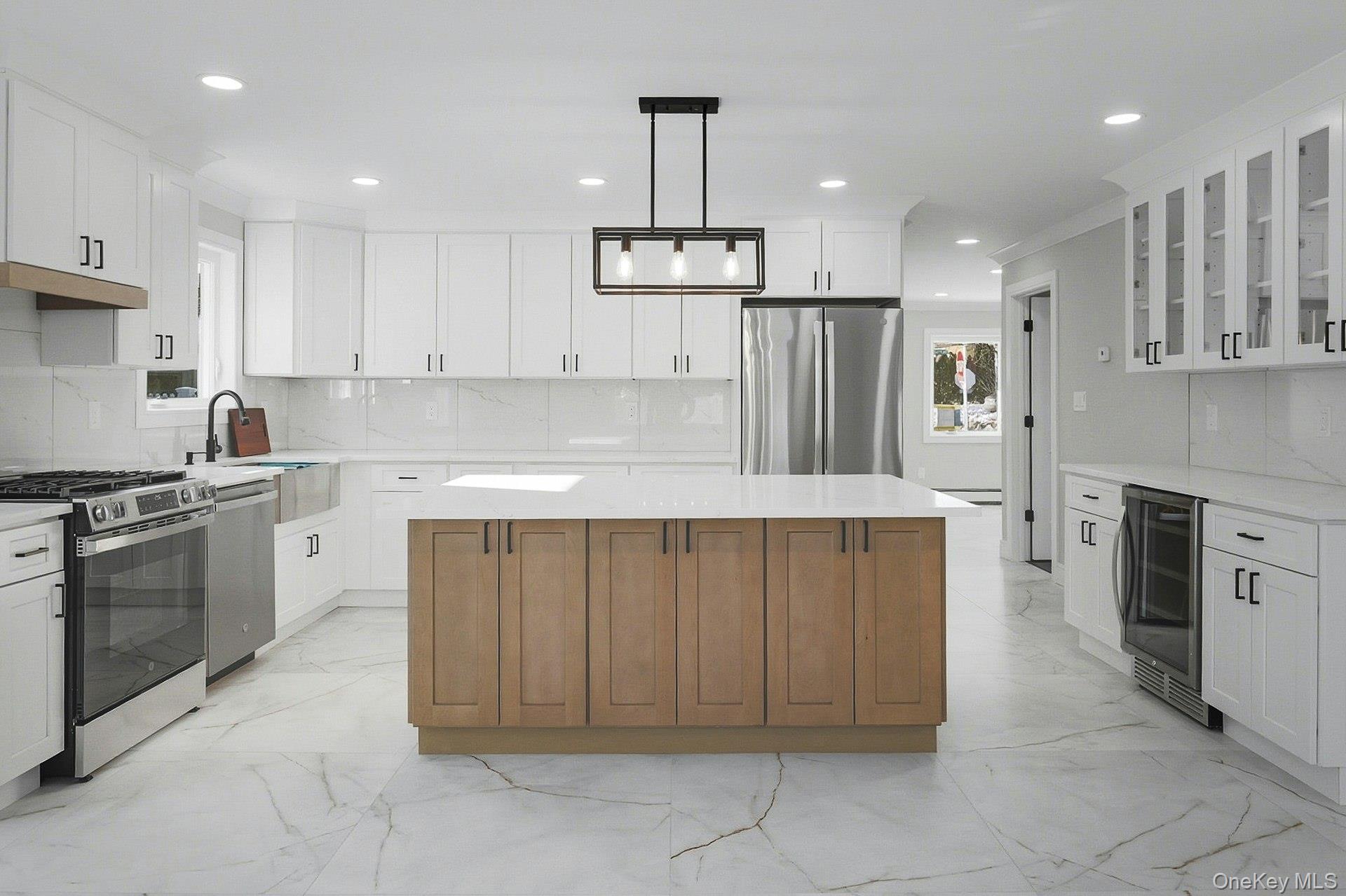 73 Wolcott Road Levittown, NY 11756 - Photo 26 of 31 a kitchen with kitchen island granite countertop a stove oven and a refrigerator