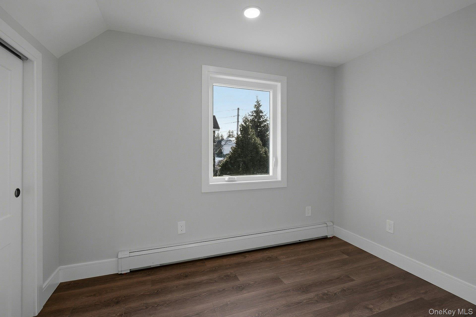73 Wolcott Road Levittown, NY 11756 - Photo 30 of 31 a view of an empty room with wooden floor and a window