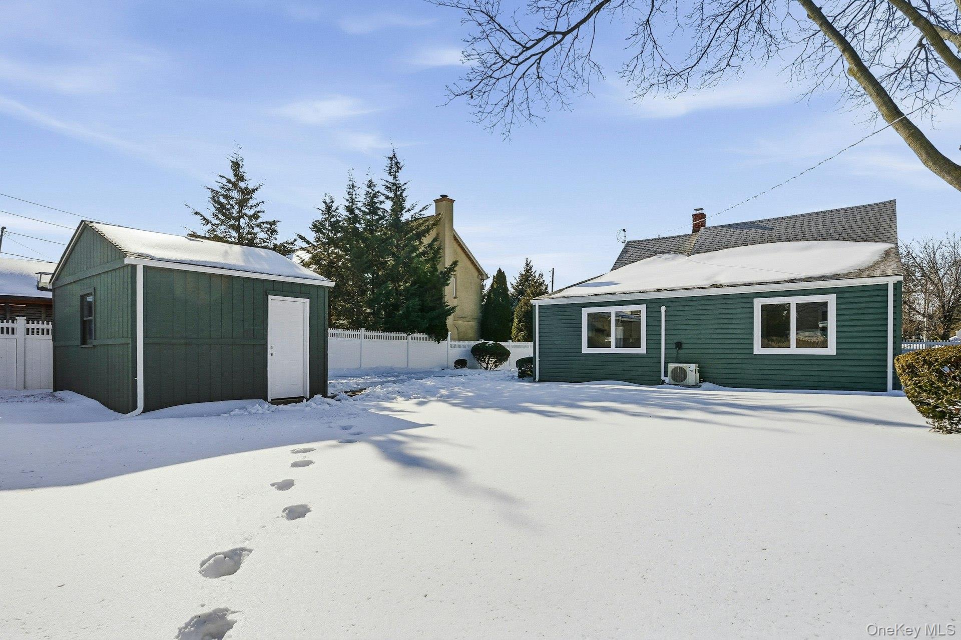 73 Wolcott Road Levittown, NY 11756 - Photo 4 of 31 a front view of a house with a yard and garage