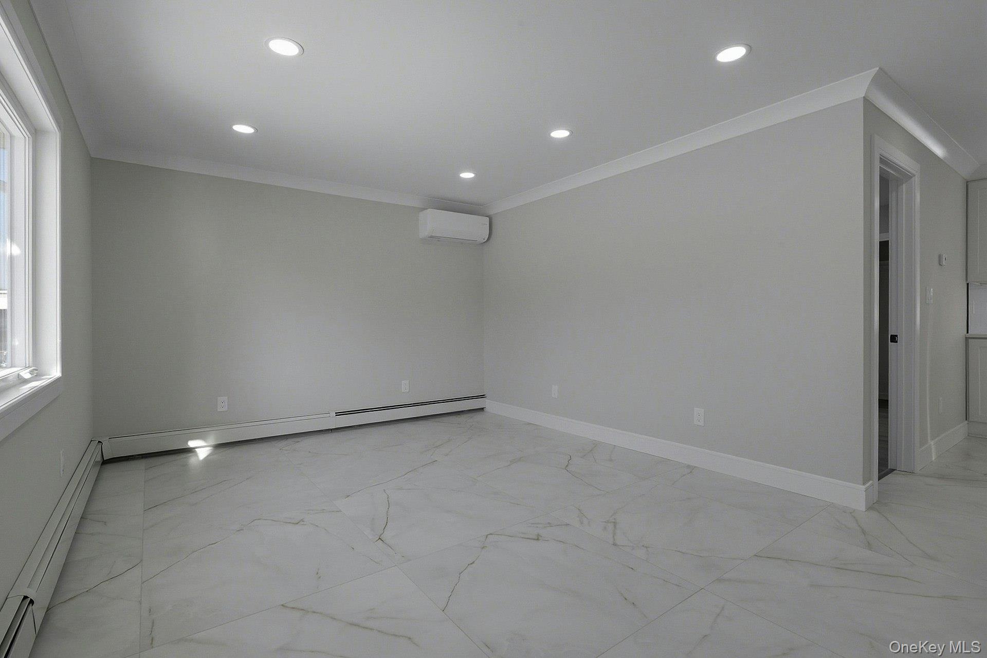 73 Wolcott Road Levittown, NY 11756 - Photo 10 of 31 an empty room with windows