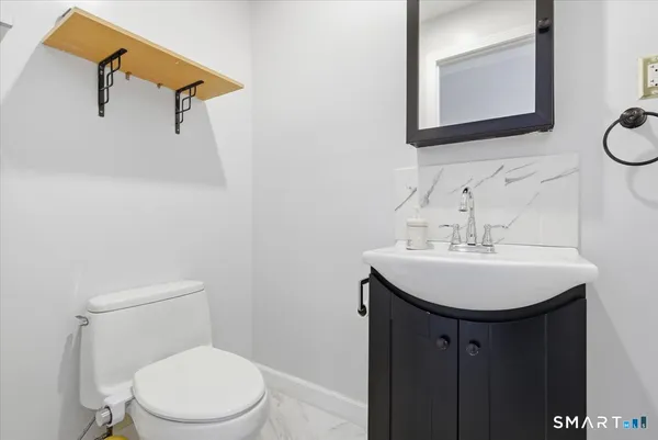 a bathroom with a sink a mirror and a toilet