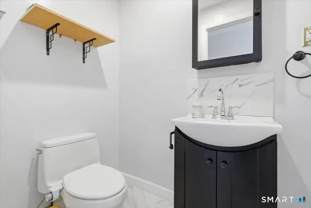 a bathroom with a sink a mirror and a toilet