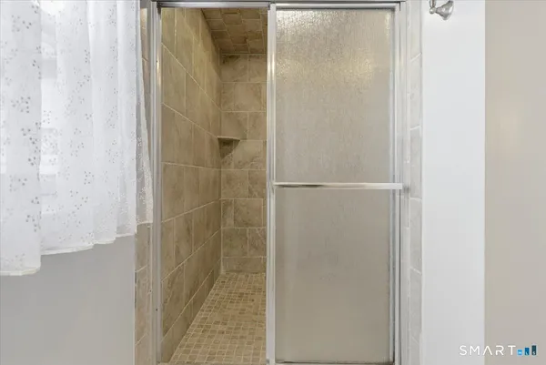 a bathroom with a glass shower door