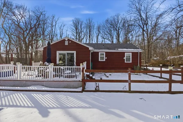 a view of a house with a wooden fence