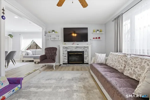 a living room with furniture and a fireplace