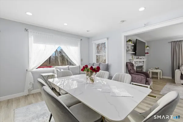 a living room with furniture and a dining table