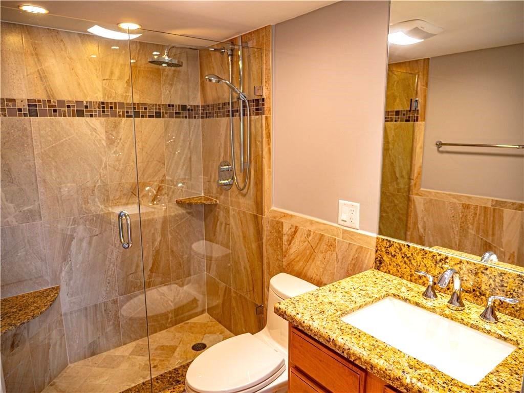328 North Ocean Boulevard, Unit 1008 Pompano Beach, FL 33062 - Photo 18 of 38 a bathroom with a granite countertop sink toilet and shower