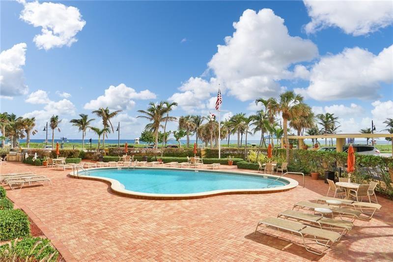 328 North Ocean Boulevard, Unit 1008 Pompano Beach, FL 33062 - Photo 23 of 38 a view of a swimming pool and trees in the background