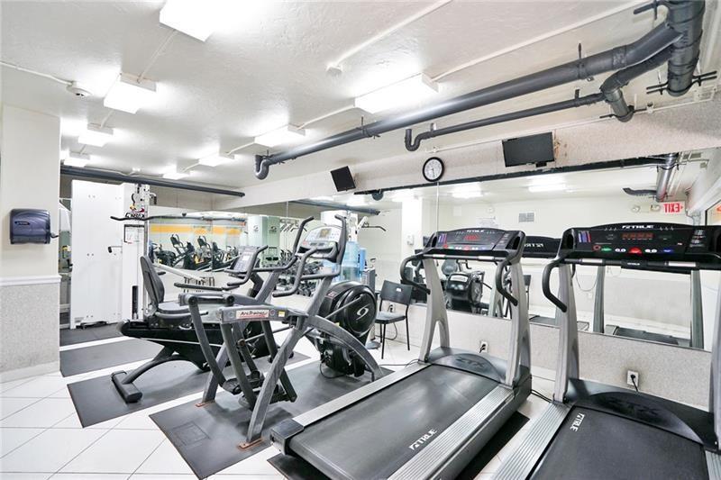 328 North Ocean Boulevard, Unit 1008 Pompano Beach, FL 33062 - Photo 24 of 38 a gym room with lots of gym equipment