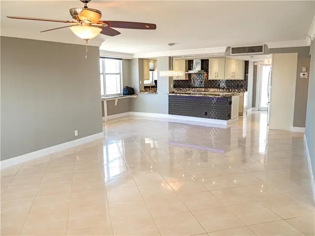 a large kitchen with kitchen island a sink stainless steel appliances and cabinets