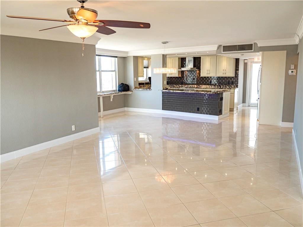 328 North Ocean Boulevard, Unit 1008 Pompano Beach, FL 33062 - Photo 10 of 38 a large kitchen with cabinets and stainless steel appliances