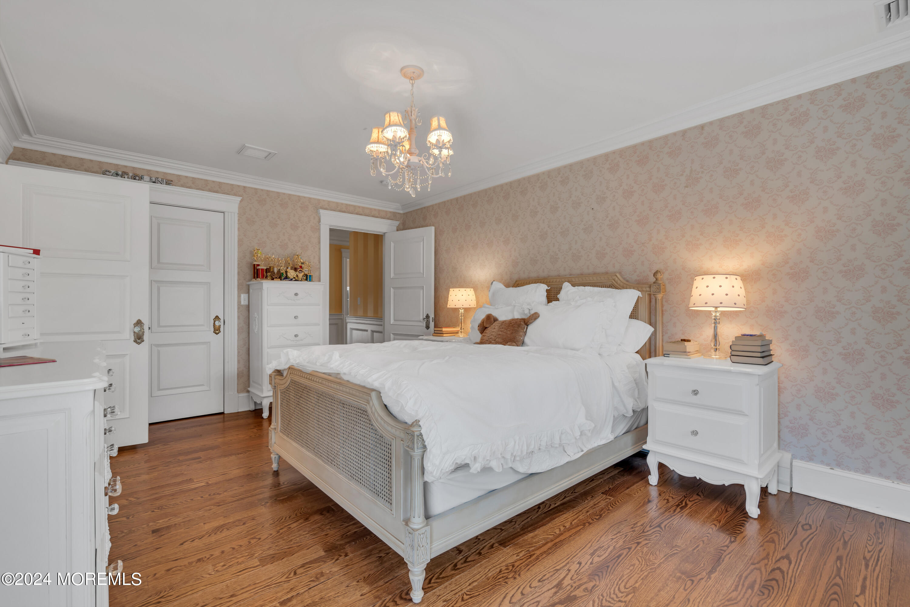 801 5th Avenue Spring Lake, NJ 07762 - Photo 49 of 97 a spacious bedroom with a bed and a chandelier