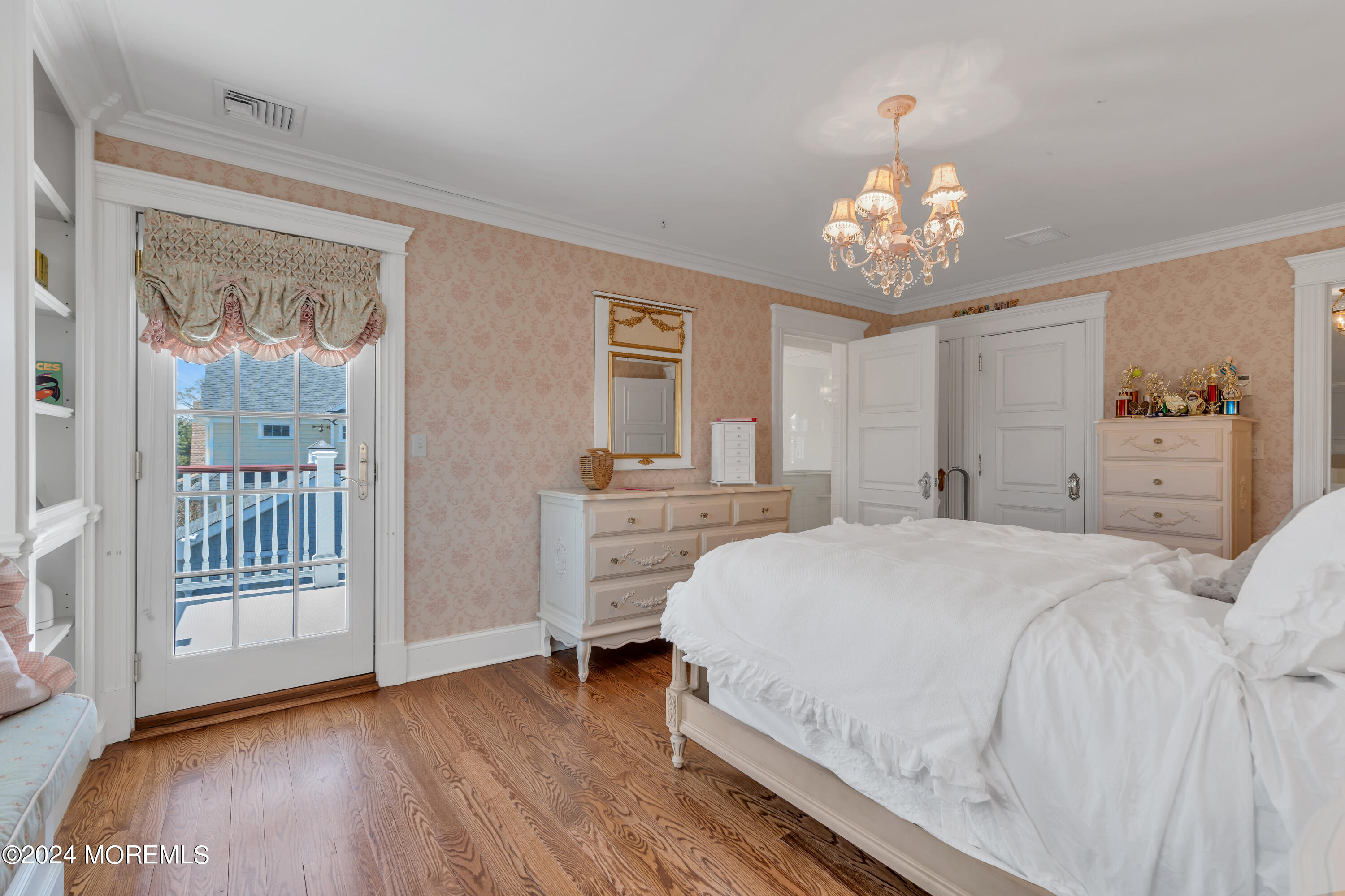 801 5th Avenue Spring Lake, NJ 07762 - Photo 51 of 97 a spacious bedroom with a bed and a table in it