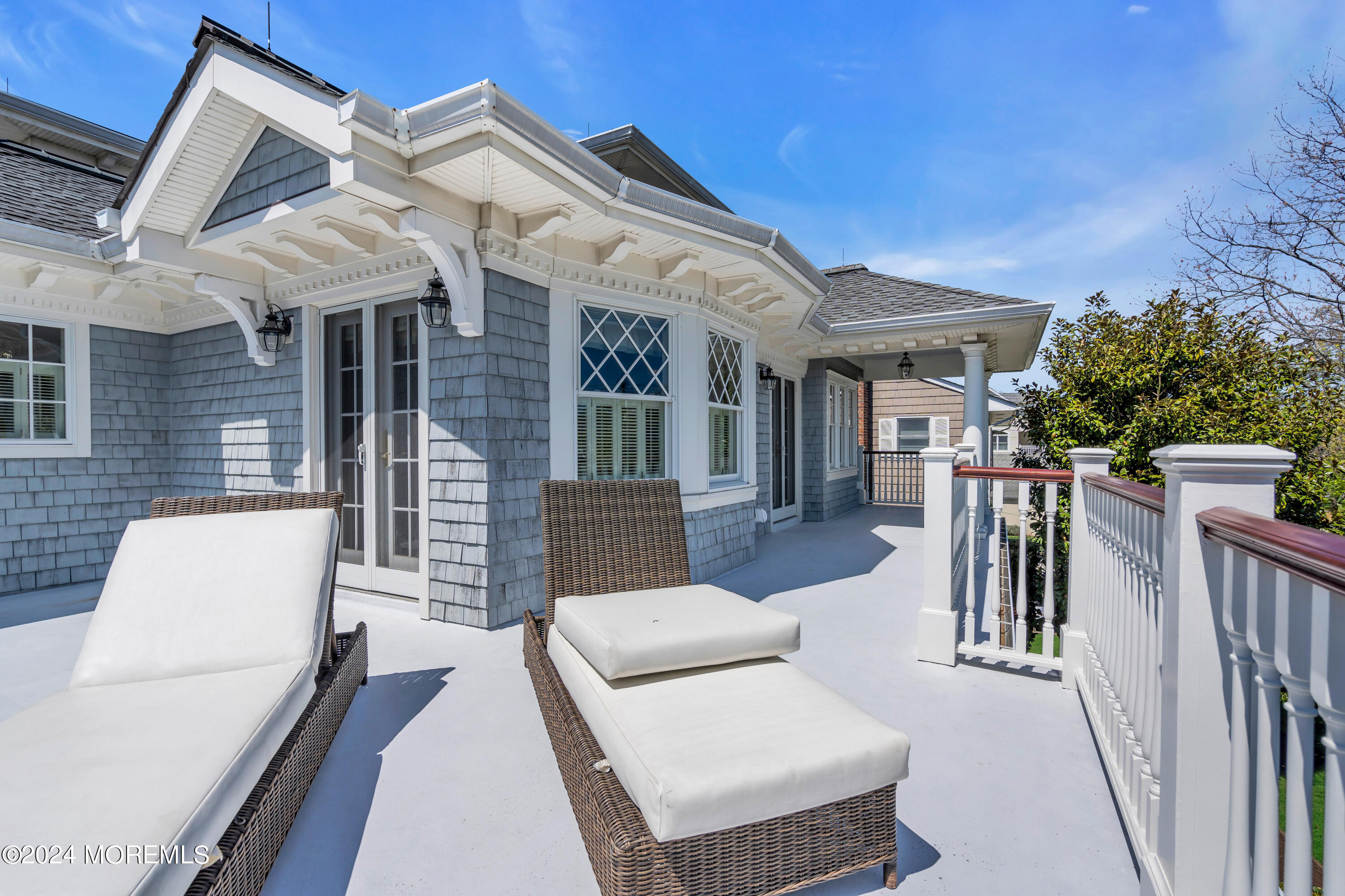 801 5th Avenue Spring Lake, NJ 07762 - Photo 96 of 97 a view of a patio with couches table and chairs with wooden floor and fence