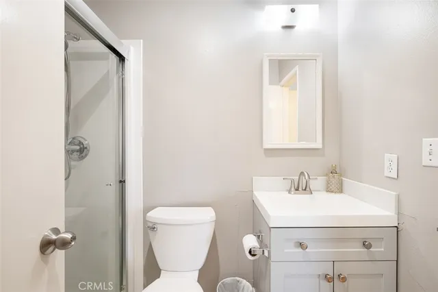 a bathroom with a sink mirror vanity and toilet