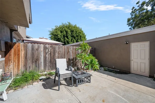 a view of a patio with table and chairs and potted plants
