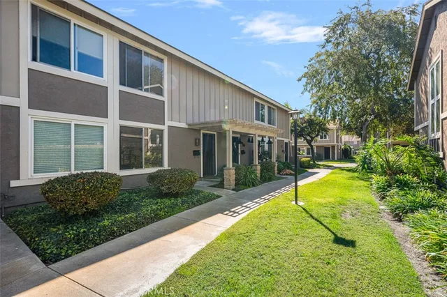 a view of a house with pool and sitting area