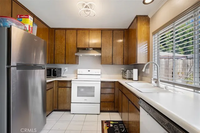 a kitchen with a sink cabinets and stainless steel appliances