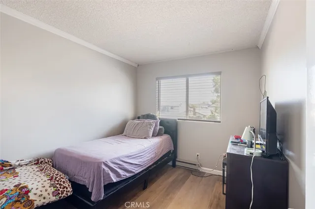 a bedroom with a bed and wooden floor