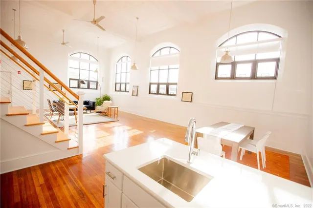 a view of a kitchen with a sink and a dishwasher with wooden floor