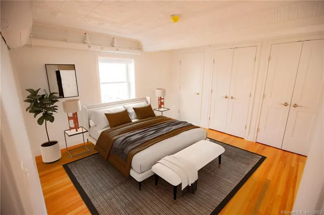 a bedroom with bed and window