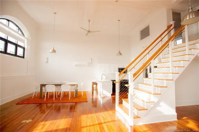 a view of entryway and hall with wooden floor