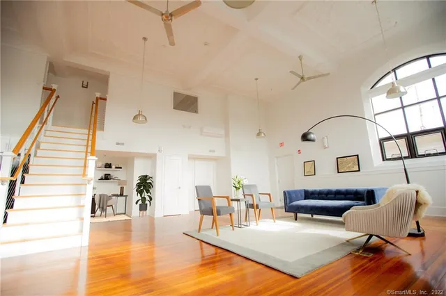 a living room with furniture and wooden floor